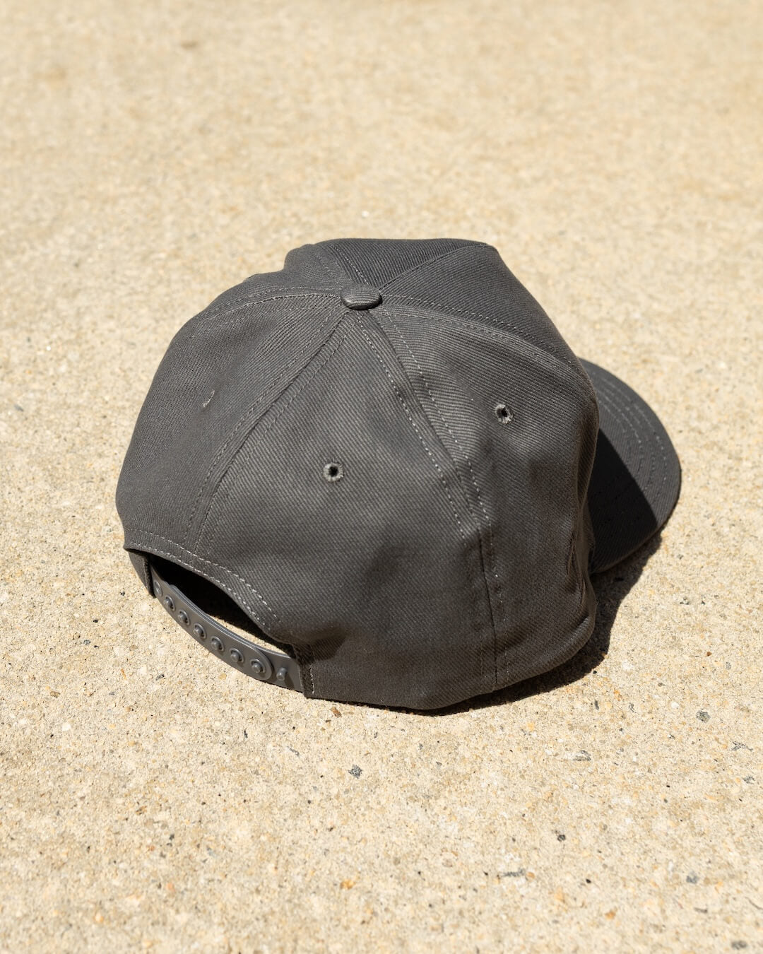 Back view of the LAGRAND Script Hat in Cinder Grey with snapback closure